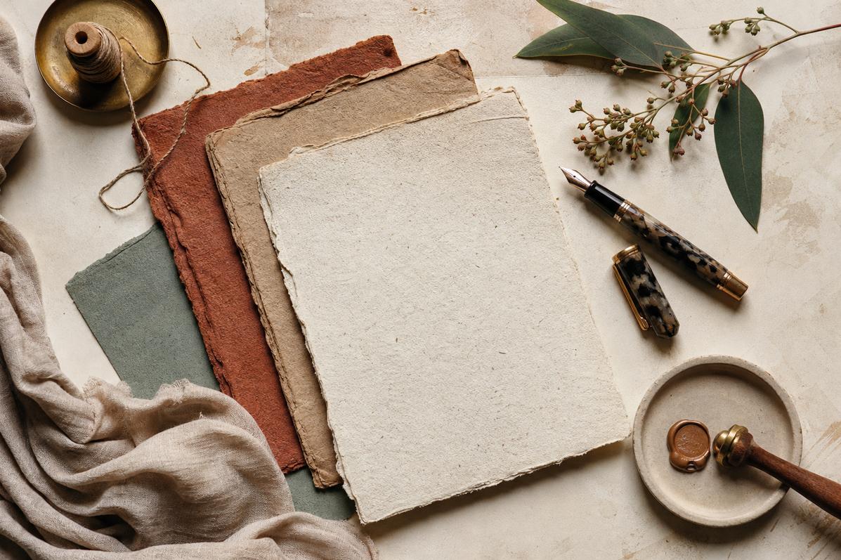 Deckle-edged handmade paper sheets with fountain pen and wax seal